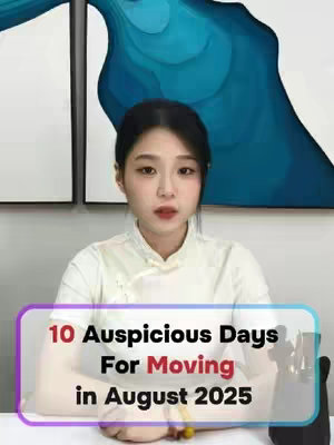 A woman sits at a desk with a white top and a light-colored collared shirt underneath. The background shows wall art with blue and white abstract shapes. The image has a text overlay in a colored box that says "10 Auspicious Days For Moving in August 2025".