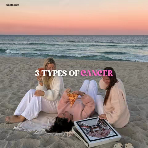 The cover image shows three young women on a beach at sunset. They are seated on the sand, with a blanket between them. Each woman is holding a slice of pizza. In the background is the ocean against a painted sky. Text overlay reads "3 TYPES OF CANCER," with "CANCER" in pink.