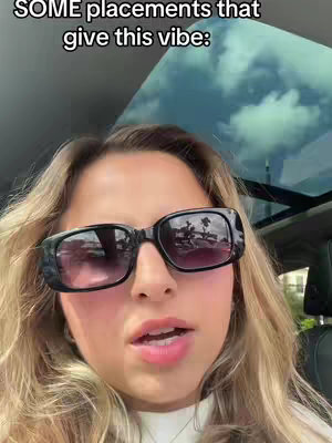 A woman with long blonde hair wearing black sunglasses, seen from the chest up, looking directly at the camera. Above her, the image captures the top of a vehicle with a partially visible tinted window and a glimpse of the sky. The text overlay reads 'SOME placements that give this vibe'.