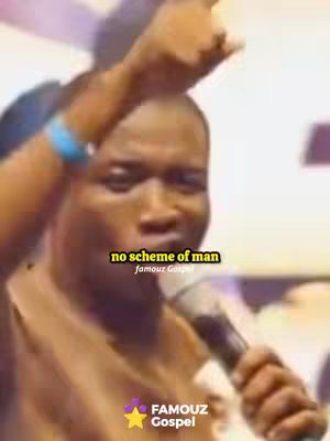 A man is speaking into a microphone, with his arm raised. Text overlays on the image.