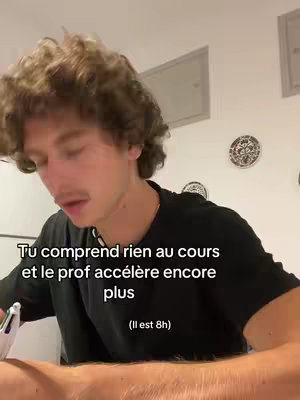 A young man with curly hair is filming himself. He's wearing a black shirt and is mid-sentence, looking slightly down and to his left. Overlay text states a relatable scenario about being lost during class.