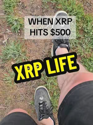 An overhead shot shows a person's legs and feet, wearing dark sneakers, standing on grass. Text overlays provide context: 'WHEN XRP HITS $500' in a white box and 'XRP LIFE' in a yellow box with a black outline.