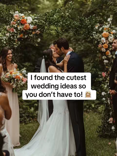 The image shows a wedding ceremony in progress. A couple is kissing in the foreground, with the bride wearing a white wedding dress and holding the groom's face. A text overlay in a white box with black text and an emoji is placed on top, sharing a text that says, 'I found the cutest wedding ideas so you don't have to!'