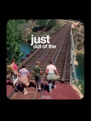The image shows five young men walking on a railway bridge. They are walking away from the camera, towards a bridge that stretches into the distance. There are trees and a body of water in the background. The text overlay is over the scene.