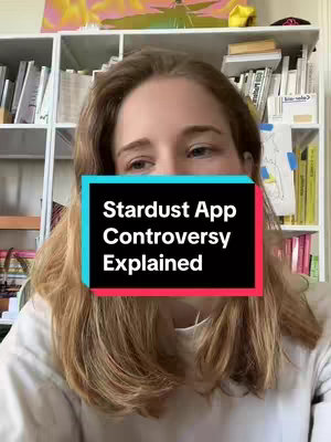 A woman with long blonde hair is centered in the frame, looking slightly down and to the left. She is wearing a white shirt. A rectangular text overlay covers a portion of her face, displaying the title 'Stardust App Controversy Explained' in bold white font against a black background with a cyan and red outline. The background includes a cluttered bookshelf and hints of artwork.