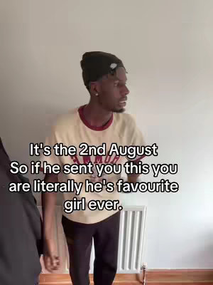 A man wearing a black beanie, a cream-colored t-shirt with a maroon collar, and dark pants stands in front of a white wall. Text overlays read: “It’s the 2nd August / So if he sent you this you / are literally he’s favourite / girl ever."