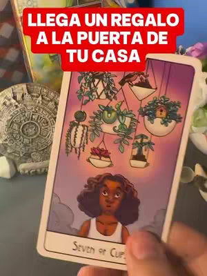 The cover image shows a tarot card presented at an angle, held in a hand. The card features a drawing of a woman with curly hair looking up at hanging plant pots, the card itself has the name of the card: "Seven of Cups." There is text overlayed on the image in a red background.
