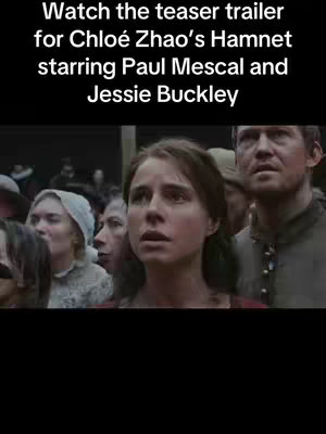 The image is a vertical frame likely taken from a movie, featuring a crowd of people looking upwards with expressions of concern and anticipation. The central focus is on a woman, presumably an actress, with a worried expression, her eyes wide and mouth slightly open. Surrounding her are other individuals, some of whom are also looking upward. The color palette seems to be natural, with muted tones and likely outdoor lighting. The layout is a medium shot or close-up, creating a sense of immediacy and focus on the characters' reactions and a text overlay at the top.