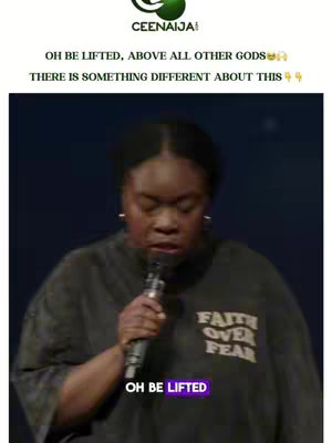 A woman with dark skin holding a microphone, eyes closed, with the text "OH BE LIFTED" in a purple box at the bottom and the text "FAITH OVER FEAR" on her shirt against a dark background.