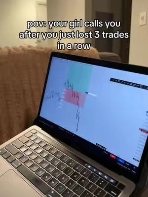 A laptop displaying a stock chart is the main focus, with a text overlay at the top. The laptop's screen shows green and red rectangular areas and a line graph, indicative of a financial analysis or trading interface. The background is out of focus, suggesting this is a personal space, likely a home environment. The color scheme is subdued, with a focus on the screen's data visualization.