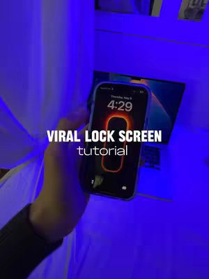 A hand holds a smartphone displaying a lock screen tutorial, with the phone angled slightly to the viewer. The background is softly lit in blue and features indistinct elements of a room setting. The title text, "Viral Lock Screen Tutorial", is prominently displayed across the image.
