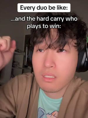 A medium shot of a young man with short, dark hair looking at the camera with a concerned expression and raising his fist in the air. Above him, white text reads, "Every duo be like: \n...and the hard carry who\nplays to win:"