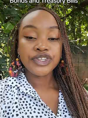 A woman with dark skin and braided hair is speaking directly to the camera. She has on large, colorful earrings, a patterned top, and is positioned in front of a background of green foliage. The image is well-lit, and her expression is friendly and engaging. Text in a white font on a dark bar below the main focal point reads, "Bonds and Treasury Bills".