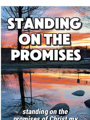The cover image displays a picturesque natural scene with a reflective body of water at the bottom, reflecting a colorful sky with pinks, oranges, and hints of blue from a sunrise or sunset. Bold, white text that says, "STANDING ON THE PROMISES" dominates the upper portion, appearing to float above the landscape. Silhouetted trees and other natural elements are visible along the horizon and the edges of the frame, adding depth and detail to the composition.