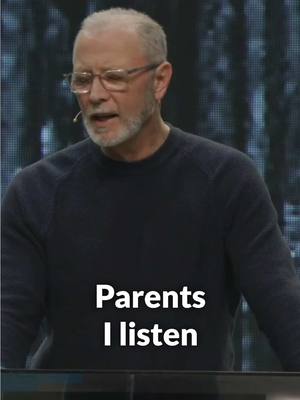The cover image features a man with glasses and a microphone, wearing a dark sweater. He appears to be speaking or presenting. The background is blurred, suggesting a stage or public speaking setting. White text overlay reads "Parents I listen".