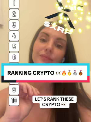 A woman is shown in a selfie-style video cover image, likely in a home setting. The background is a plain wall. The woman is positioned centrally, with her face and upper body visible. She is looking slightly up and to the side. The image includes text overlays: a numbered list from 1 to 10, and the phrase "RANKING CRYPTO" along with various emojis to indicate the video topic.