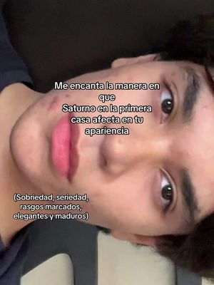 A selfie portrait of a young person with slightly tilted presentation, facing towards the viewer, with a close-up on the face. The person has dark hair and prominent features, and the image has text overlays about astrology focused on the signs of the Zodiac.