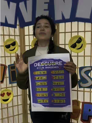 The image shows a woman holding a presentation board about a Bible-themed quiz. She is standing in front of what appears to be a room divider, with smiley face decorations. The woman is centered, holding the board. The board contains text and images. The overall tone is educational and inviting.