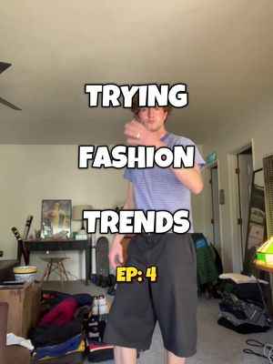 A man wearing a blue striped t-shirt and black shorts stands in a room with miscellaneous items in the background. Overlayed text in bold white font with a black outline reads: TRYING, FASHION, TRENDS, and EP:4.