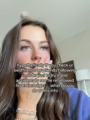 The image shows a close-up of a young woman with long brown hair. She is wearing a purple top and a collection of bracelets on her wrist. She is holding her hand up to her face, near her mouth, in a contemplative pose. The background appears to be a room with neutral-colored walls. Text overlayed over the image poses a hypothetical situation.