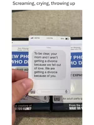 A hand holding a card overlaid on top of other cards, presenting a text message conversation. The message indicates a divorce, causing a humorous/sad effect. The background is subtly textured.
