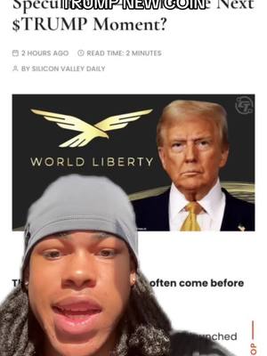 A selfie video showing a young man's face in the foreground, partially obscuring content from a news article about a new cryptocurrency named after Donald Trump. The news article is in the top half of the visual and features an image of Donald Trump. The creator, has short dreadlocks, is wearing a gray beanie, and is looking directly at the camera with an open mouth. The background consists of a news article.