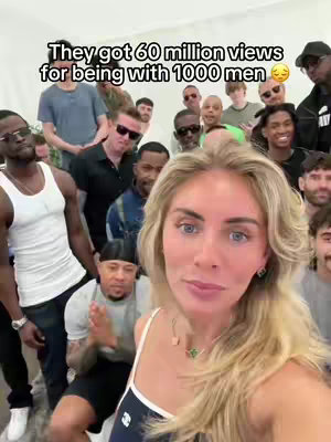 A woman with blonde hair is in the foreground, smiling at the camera. Behind her, a crowd of men are gathered. The text overlay at the top reads, 'They got 60 million views for being with 1000 men.'