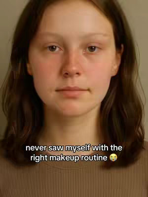 A close-up shot of a young person with light skin and long brown hair, looking directly at the camera with a neutral expression. The background is a plain, warm beige color, and the person is wearing a simple brown ribbed top. Text overlayed on the image says, 'never saw myself with the right makeup routine' along with a smiling emoji.