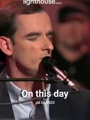 A man with dark hair is singing into a microphone in front of a blurred background. Text overlays say 'lighthouse....' at the top and 'On this day Jul 24, 2023' at the bottom.