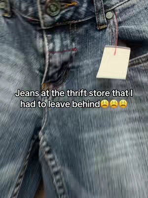Close-up shot of a pair of denim jeans, specifically focusing on the upper portion that includes the waistline, buttons, and a tag. The jeans are a medium to light wash, with visible wear and slight fading. Text is overlaid on top of the jeans, describing the situation.
