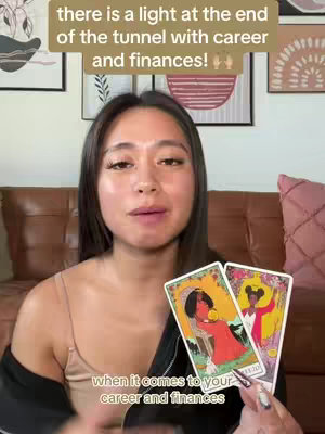 A young woman with brown hair and a light complexion looks directly at the camera, holding two tarot cards. Above her, text provides context, while below, the image features a couch background.