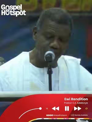 The cover image shows a man with dark skin, wearing a white shirt and a microphone in front of him, suggesting he is speaking or singing. The background is blurred. The bottom third has a red bar with video controls and the title 'Ewi Rendition' and the name of the artist.
