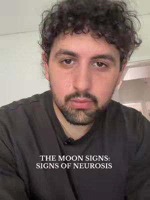 A close-up shot of a man with curly dark hair and a beard, looking directly at the camera with a neutral expression. Text overlay says 'THE MOON SIGNS: SIGNS OF NEUROSIS'.
