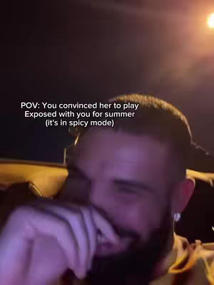 The cover image presents a close-up of a man with a beard, appearing in an indoor setting with low lighting. The man is smiling and has his hand covering his mouth. Text overlay reads: "POV: You convinced her to play Exposed with you for summer (it's in spicy mode)"