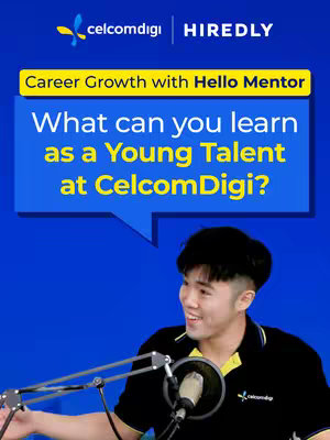 A young man wearing a black polo shirt is holding a microphone in front of a blue background. Text overlays are in the image, including the logos of "celcomdigi" and "HIREDLY". There a speech bubble shape in the image above the man.