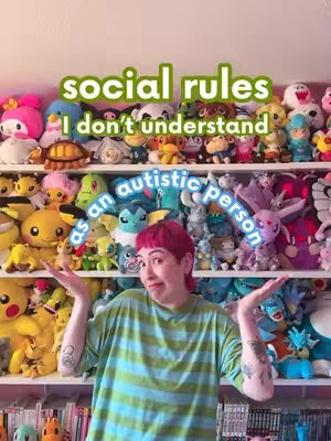 A woman with pink hair stands in front of shelves filled with various plush toys. Text overlays read 'social rules I don't understand as an autistic person'. The woman is gesturing with her hands and wearing a green and white striped shirt.