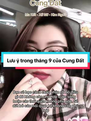 The cover image features a woman in glasses in the center. Above her is text in a stylized handwritten font that says "Cung Dat" in Vietnamese. Beneath this are the names of the zodiac signs: "Ma Kết - Xử Nữ - Kim Ngưu." A text overlay with a white background spanning the lower third of the image reads "Lưu ý trong tháng 9 của Cung Đất" in a bold font with a red bottom bar, followed by more text in a similar style.
