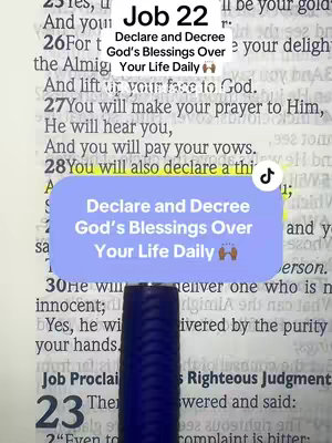The image is a close-up shot of an open Bible, with the text of Job 22 visible. A blue and white box is placed over the text, with the words "Declare and Decree God's Blessings Over Your Life Daily". A black pen is present in the frame pointing to the text.