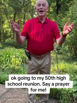An older man stands outdoors with his arms outstretched. He’s wearing a red polo shirt and khaki pants. The background shows lush greenery. A white text box towards the lower part of the image contains the caption text.