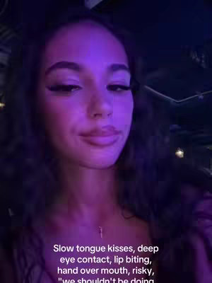 A close-up selfie features a woman with dark hair and a neutral expression. She's lit with a purple light, and text overlays the bottom, hinting at romantic or intimate themes.
