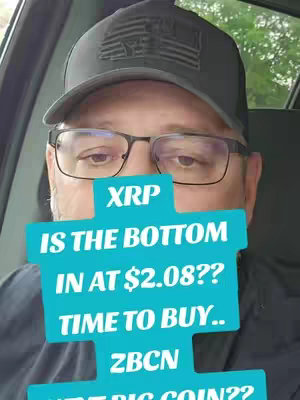 A man wearing a cap, glasses, and a dark shirt is shown from the chest up. A turquoise graphic that partially obscures his face contains text. The background appears to be the interior of a vehicle with a blurred view of greenery outside.