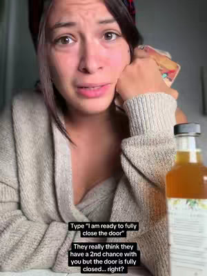 A close-up shot of a woman's face, expressing sadness. Her eyes are filled with tears, and she is touching her cheek. An open bottle is visible in the background, with overlay text at the bottom.