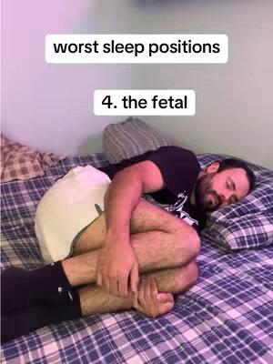 The image features a man lying in a fetal position on a bed covered with a plaid sheet. Above him, text indicates the worst sleep positions. The man is wearing a black t-shirt and white shorts, and a pillow is visible near his head.