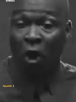 A black and white close-up of a man with a shocked expression, his mouth open. Text overlays are present with warnings.