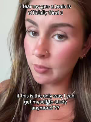 A close-up of a young woman's face. She has long, light brown hair, and her makeup includes visible blush and mascara. Text overlays are positioned above and below her face.