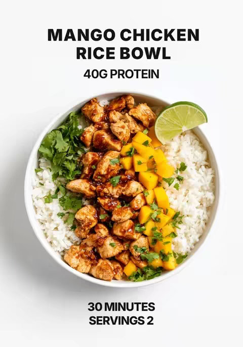 A top-down shot presents a white bowl filled with a colorful and appetizing meal. The bowl's contents are divided into sections: fluffy white rice, cubed, cooked chicken pieces coated in a rich sauce, diced yellow mango, fresh cilantro, and a lime wedge. Black text at the top reads 'MANGO CHICKEN RICE BOWL'. Below, the text highlights the protein content, and further down, it notes the prep time and the number of servings.