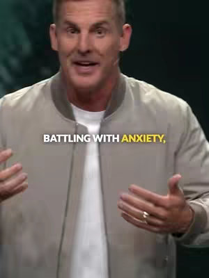 A man in a bomber jacket is speaking to the camera, with text across the bottom.