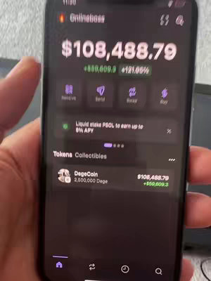 A person is holding a black smartphone displaying a cryptocurrency app interface. Key data points are highlighted on the screen, including a substantial amount of money in US dollars and the ticker of an altcoin.