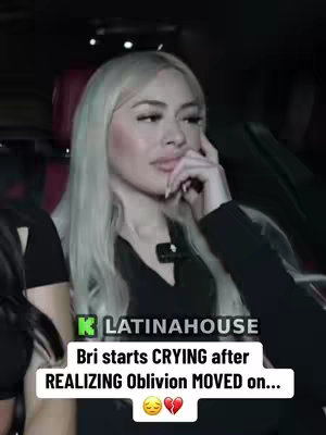 A woman with long blonde hair is sitting in a car, looking at something off-screen with a melancholic expression. She is wearing a black top, and her hand is touching her face. Below her is a text overlay on a black background, with the title of the post.