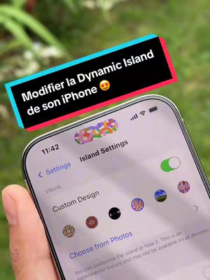 The cover image displays a close-up of an iPhone screen with a colorful overlay at the top, resembling a modified Dynamic Island. Below the island, it shows app settings. A hand partially holds the phone, set against a blurred green background with sunlight.